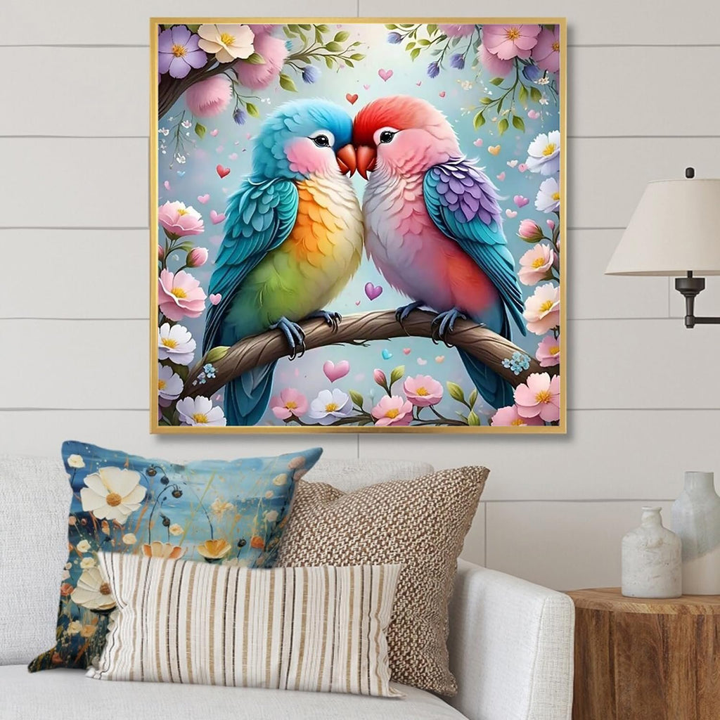 Two lovebirds perched on a branch surrounded by flowers and hearts, framed artwork on a wall.