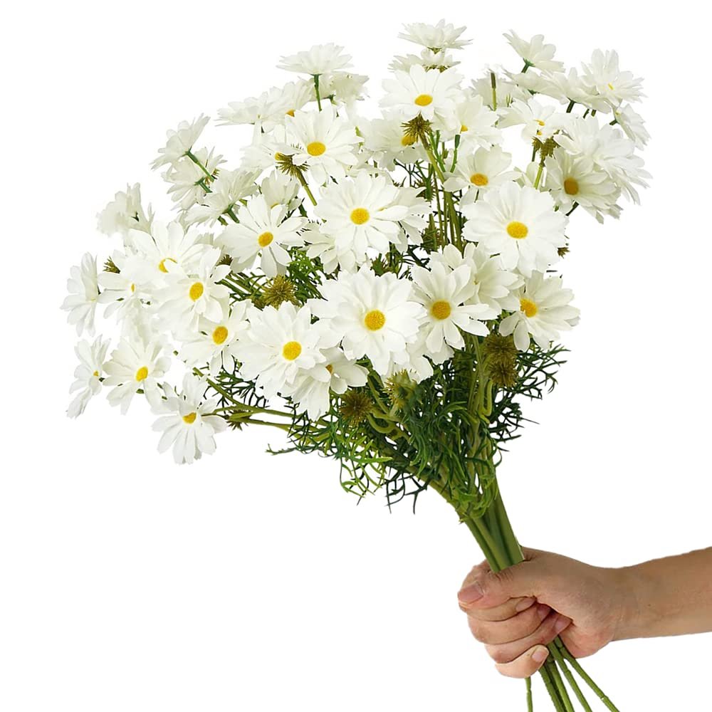 Hand holding a bundle of 15 artificial white daisy flowers with yellow centers and green stems against a white background.