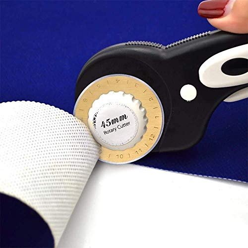 Close-up of a 45mm rotary cutter slicing through white fabric on a blue background.