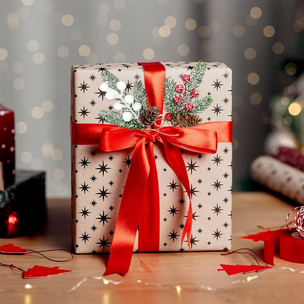 Gift-wrapped box with red ribbon and artificial holly berry sprigs, pinecones, and pine needles