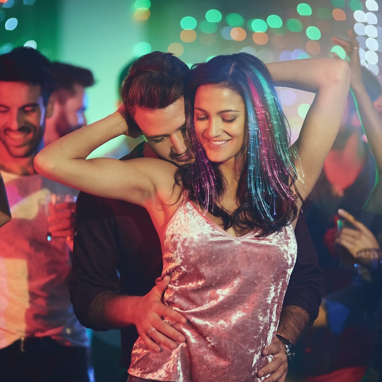 Couple dancing at a party with colorful LED fiber optic hair extensions glowing
