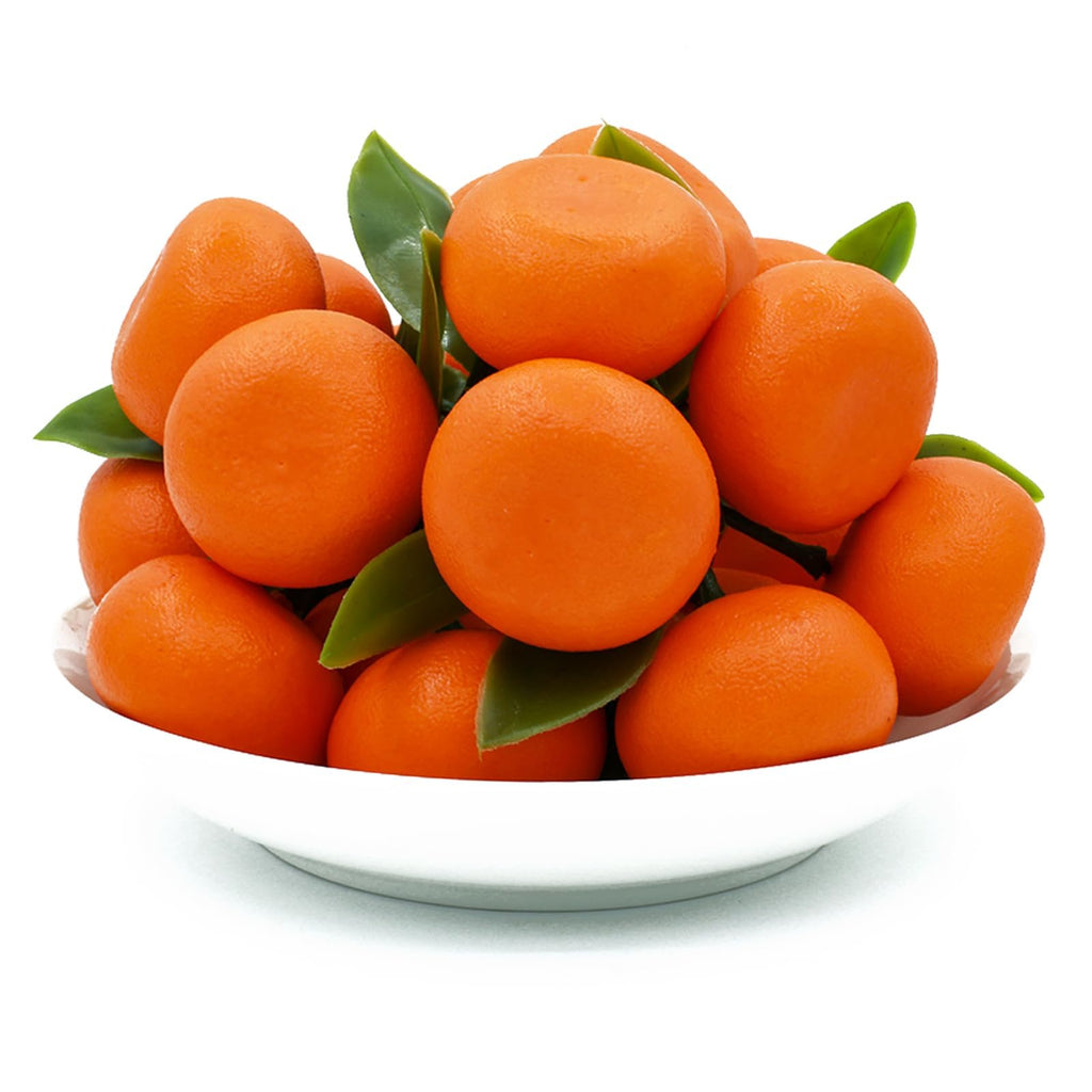 Bowl of 15 mini artificial oranges with green leaves, close-up front view