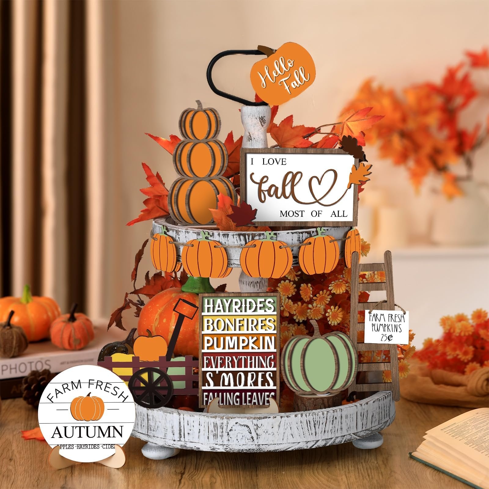 Thanksgiving tiered tray decor set with stacked pumpkins, fall leaves, and signs saying 'I love fall most of all' and 'Farm Fresh Pumpkins'.