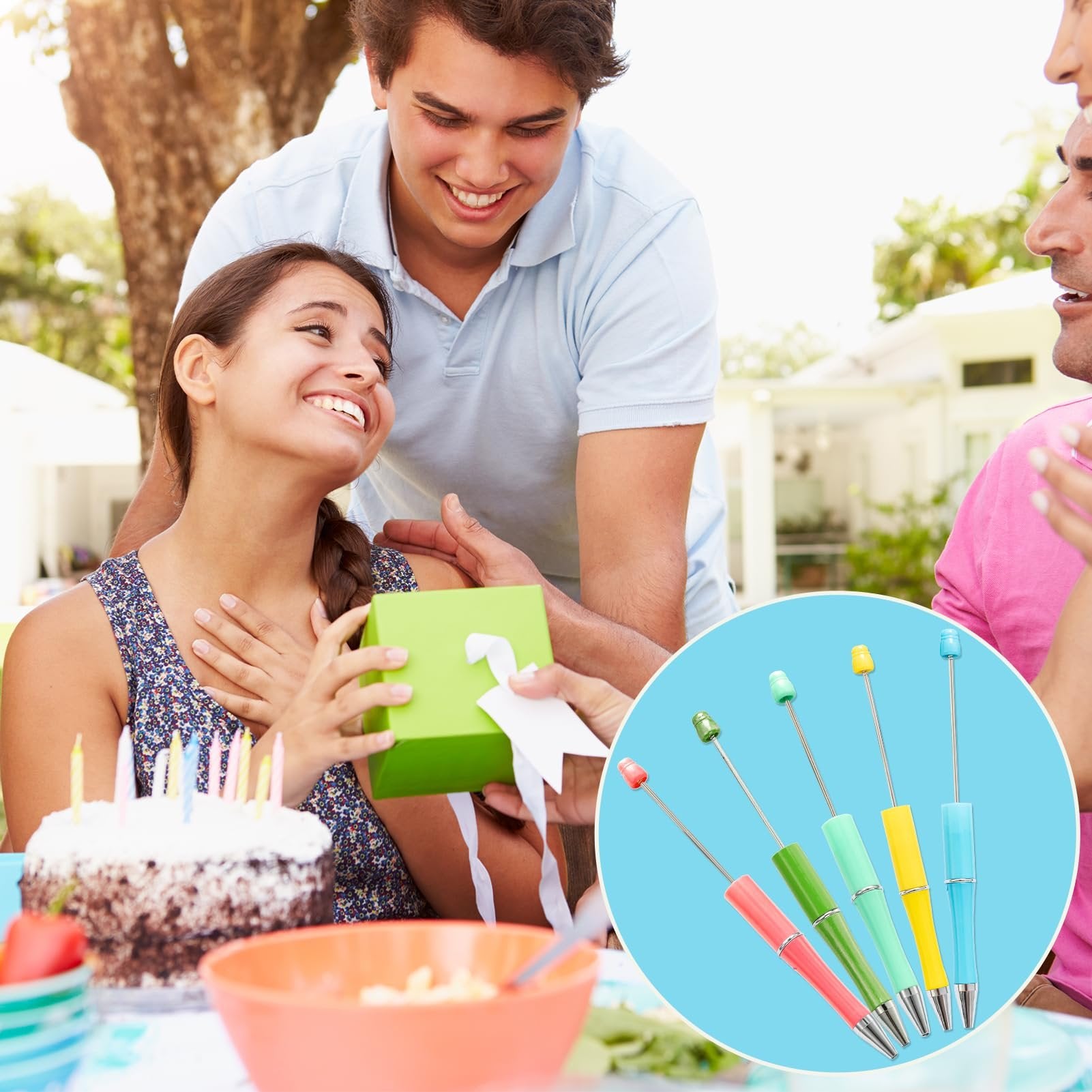 Group of people celebrating a birthday outdoors with a cake, one person receiving a gift, and a circular inset showing colorful beadable pens.