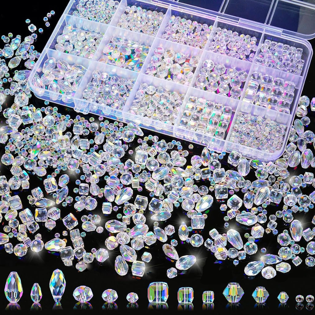 Assortment of clear AB color crystal glass beads in various shapes and sizes, spilling from an organizer box.