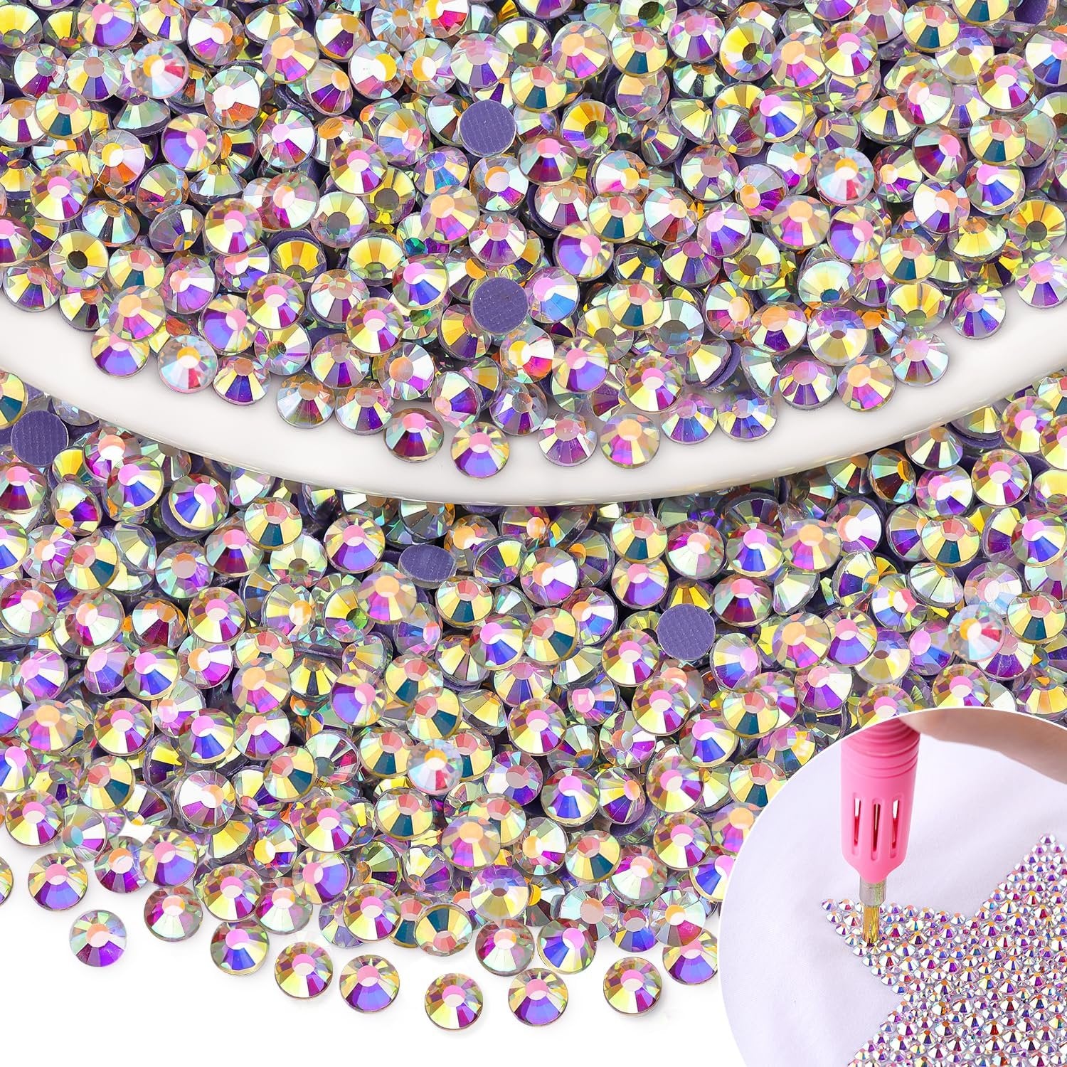 Pile of iridescent AB hotfix rhinestones with a pink applicator tool applying them to a surface in a star shape.