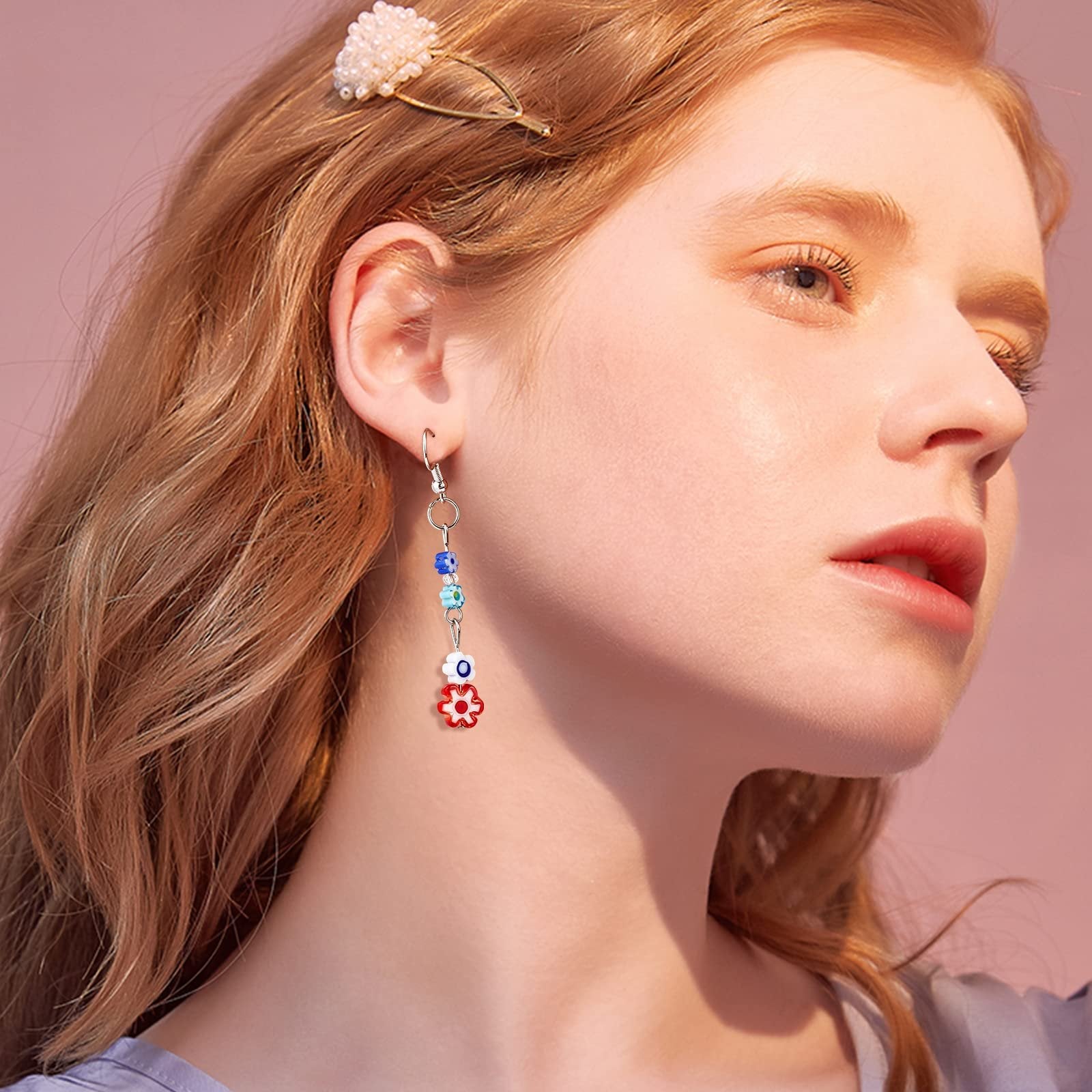 Close-up of a woman wearing a dangling earring with colorful flower-shaped glass beads and small round beads.