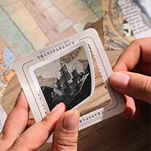 Hands holding a clear plastic frame with a vintage ship image, over a map background. Text reads ROTOCHROME TRANSPARENCY.