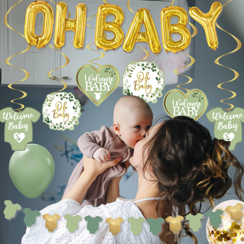 Mother holding baby with sage green and gold "Oh Baby" and "Welcome Baby" decorations