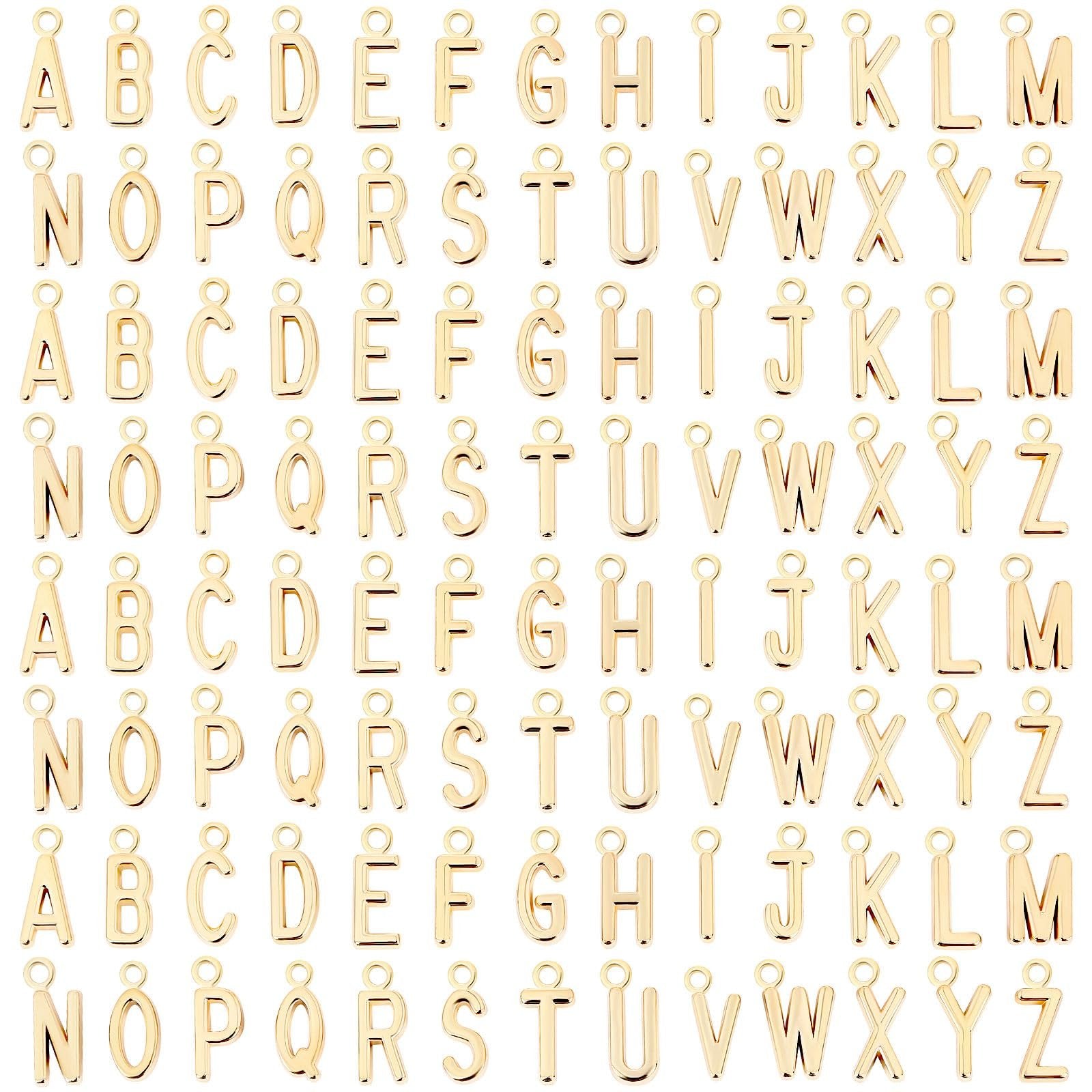 Gold-tone alphabet letter charms arranged in rows on a white background.