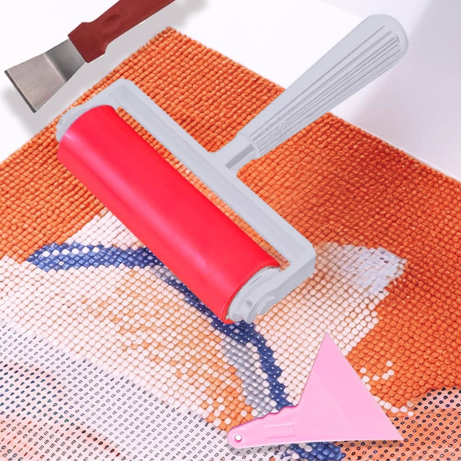 Diamond art roller tool and scraper on a partially completed diamond painting canvas