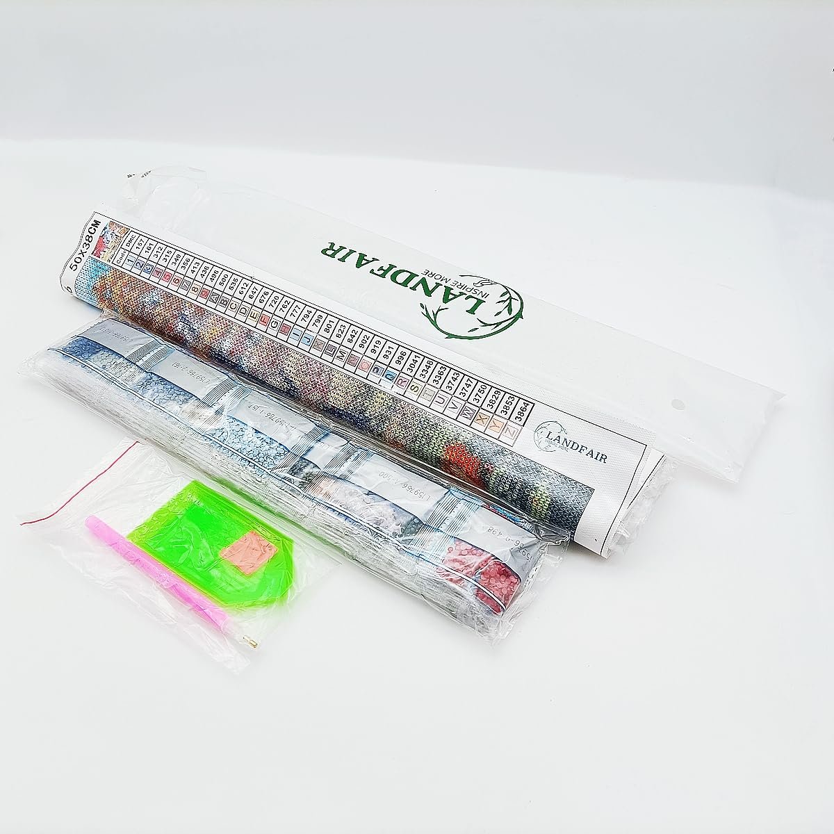 Diamond painting kit contents including canvas, diamond bags, and tools on a white background.