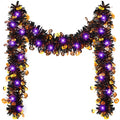 Halloween tinsel garland with purple LED lights and pumpkin sequins, displayed in an M-shape against a white background.