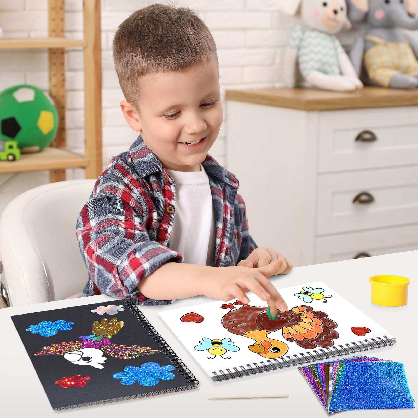 Young boy crafting with a foil art kit, applying foil to a drawing of a turkey and bees.
