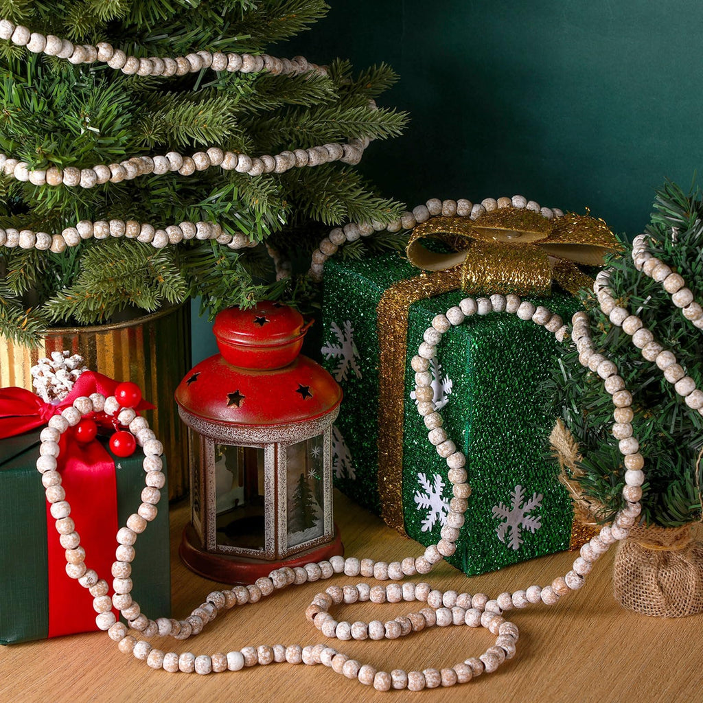 Christmas wood bead garland draped around decorated trees and gifts, featuring a red lantern.