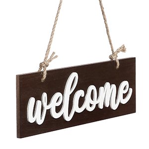 Dark brown wooden welcome sign with white cursive lettering, hanging by rope.