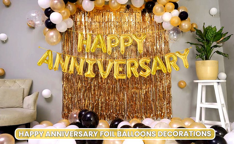 Gold foil balloons spelling 'Happy Anniversary' hang in front of a gold fringe curtain, surrounded by other balloons and decor.