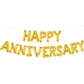 Gold foil letter balloons spelling HAPPY ANNIVERSARY strung on a yellow cord against a white background.