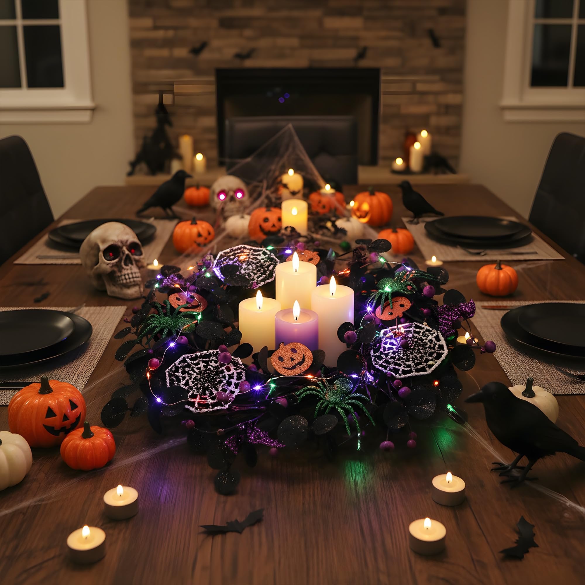 Halloween table setting with a wreath, pumpkins, skull, crows, and candles.