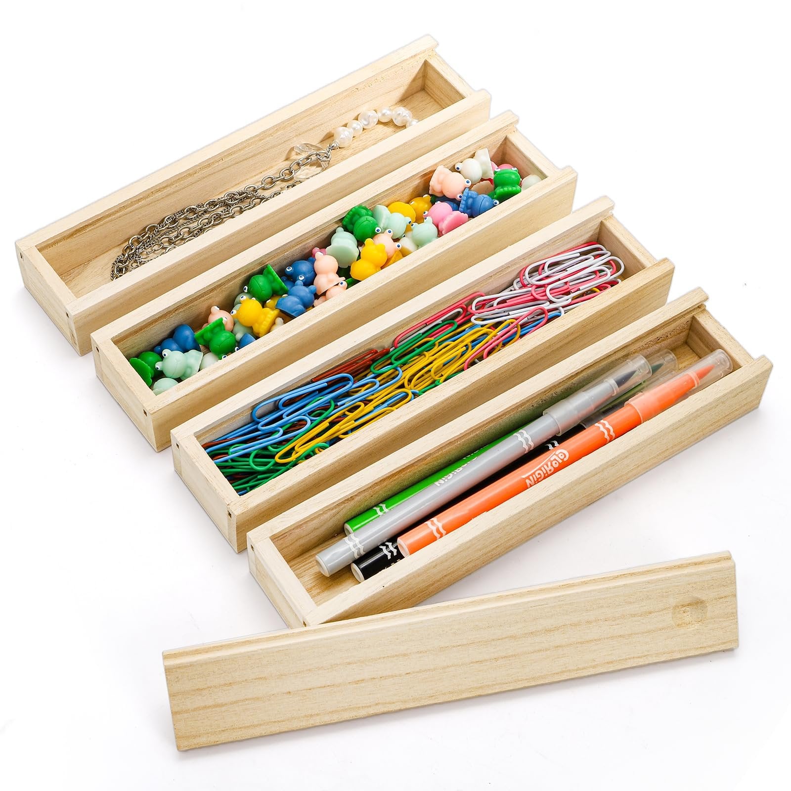 Four unfinished pine wood boxes filled with craft supplies and stationery on a white background.