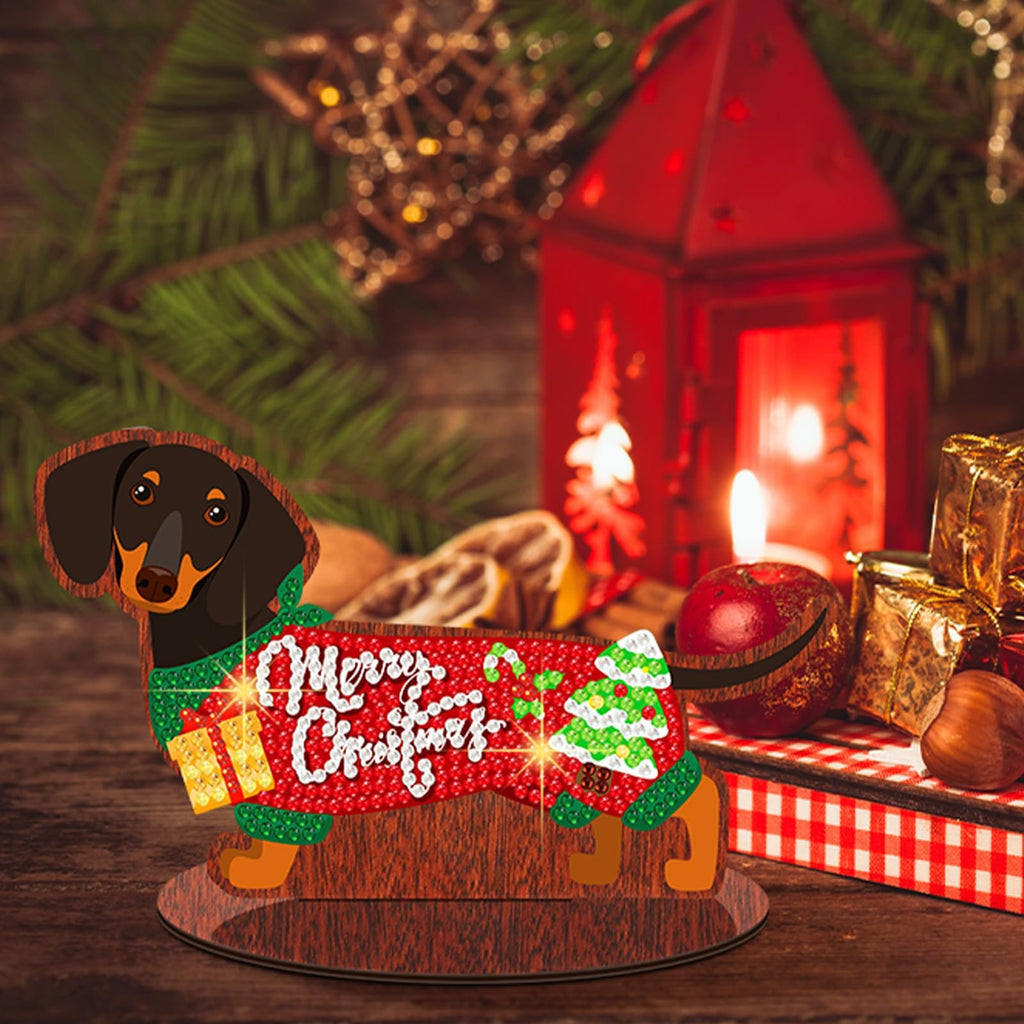 Dachshund diamond art kit centerpiece with 'Merry Christmas' text, gift, and tree design, on a wooden table with festive decor.