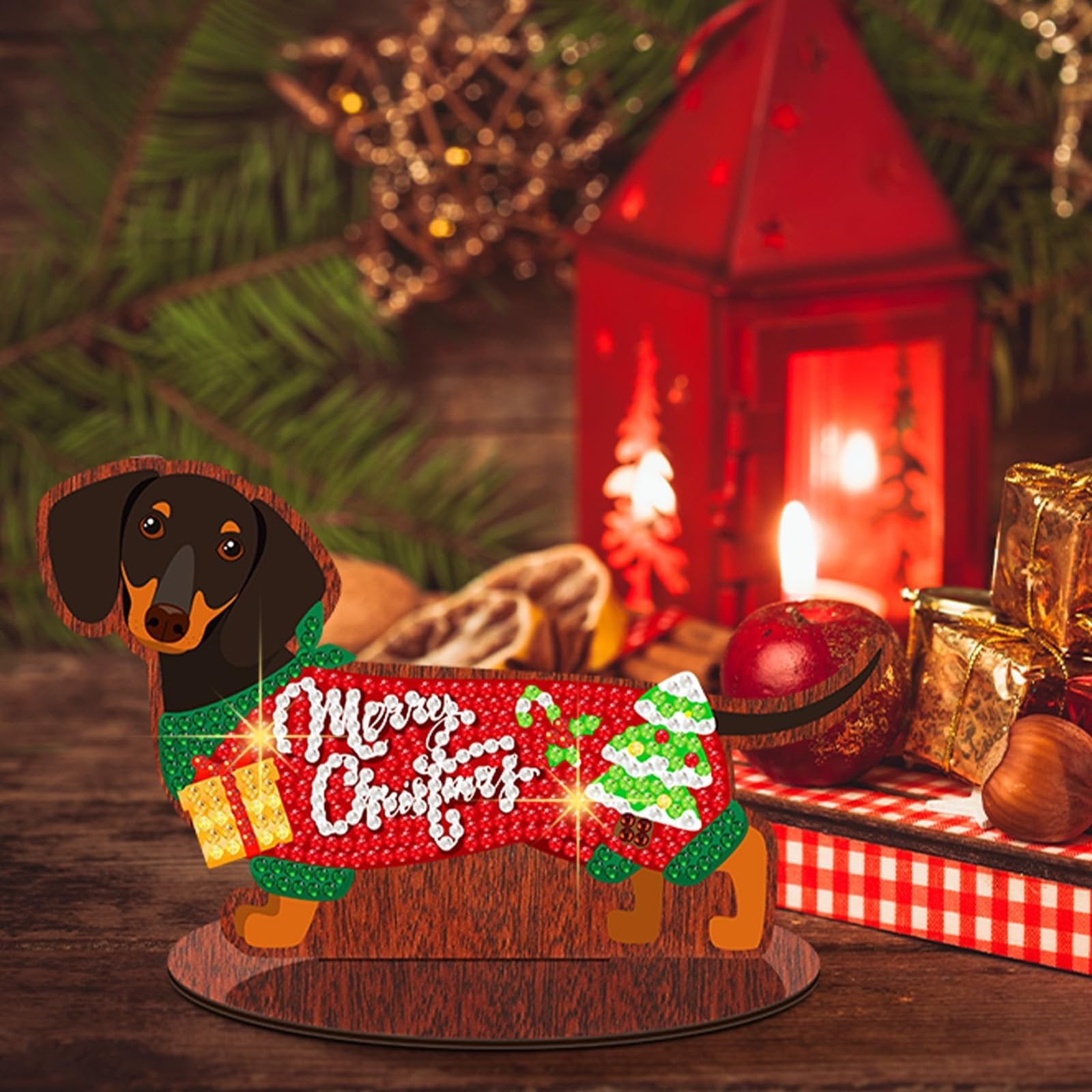 Dachshund diamond art kit centerpiece with 'Merry Christmas' text, gift, and tree design, on a wooden table with festive decor.