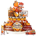 Thanksgiving tiered tray decor with pumpkins, a gnome, and fall-themed signs.