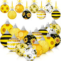 Collection of 16 yellow and black bee and sunflower themed round hanging ornaments with silver caps and yellow ribbons.