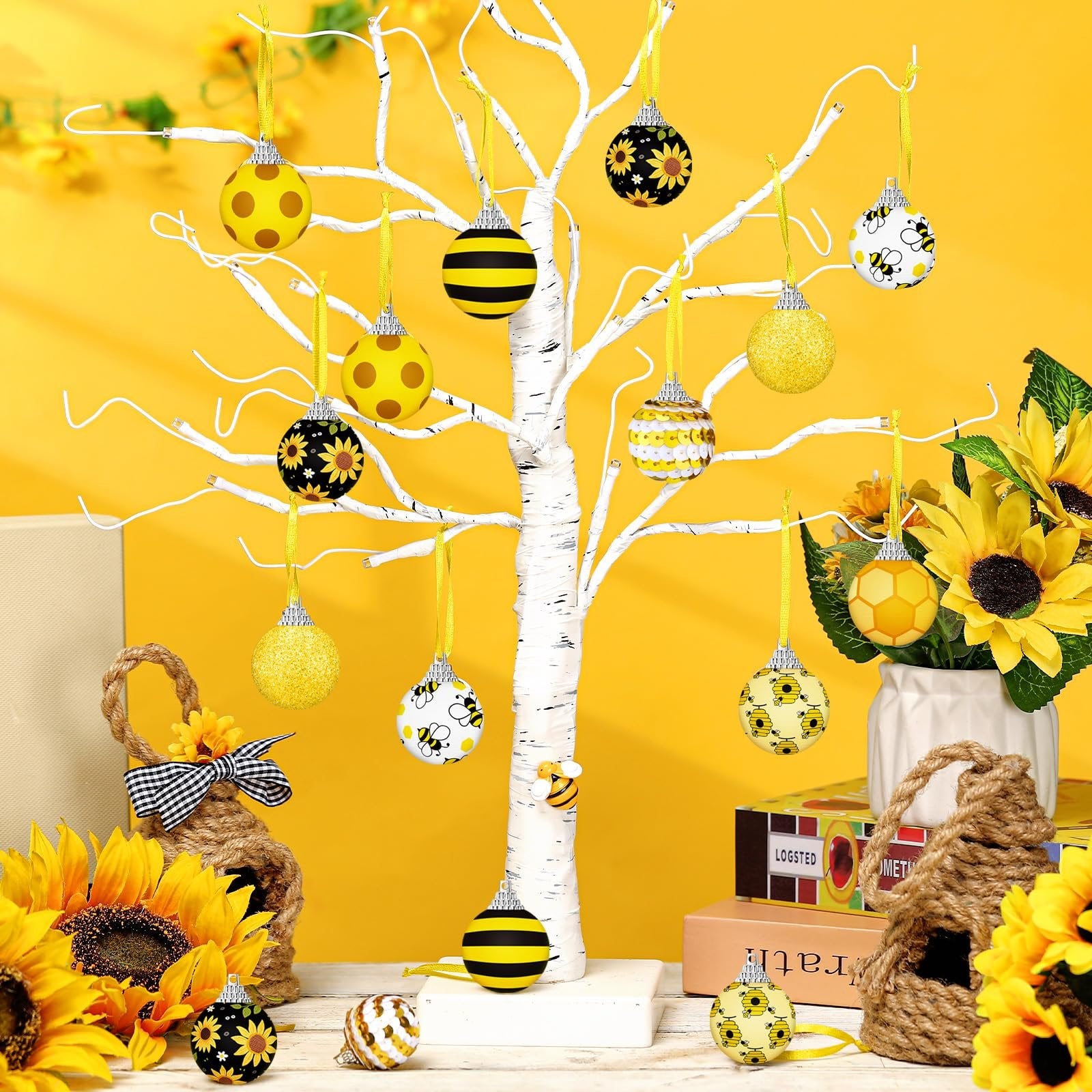 Yellow sunflower and bee ornaments hanging on a white tree with sunflowers and decorative bee houses.