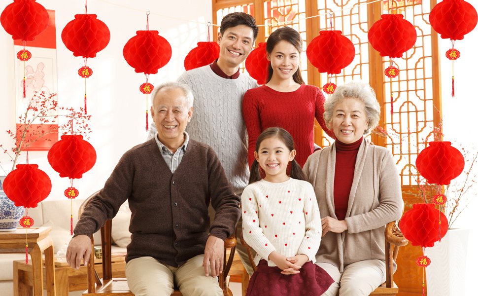 Family celebrating Lunar New Year with red hanging lanterns and decorative branches