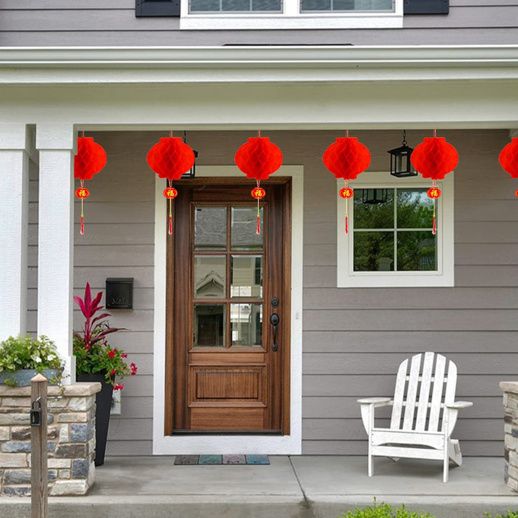 Red hanging lanterns with gold tassels decorate a porch during Lunar New Year celebrations.