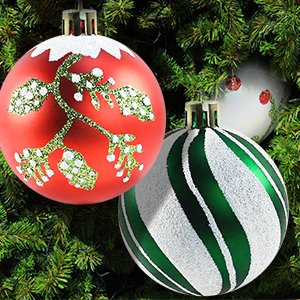 Three shatterproof Christmas ball ornaments with glitter and striped designs hanging on a pine tree branch.
