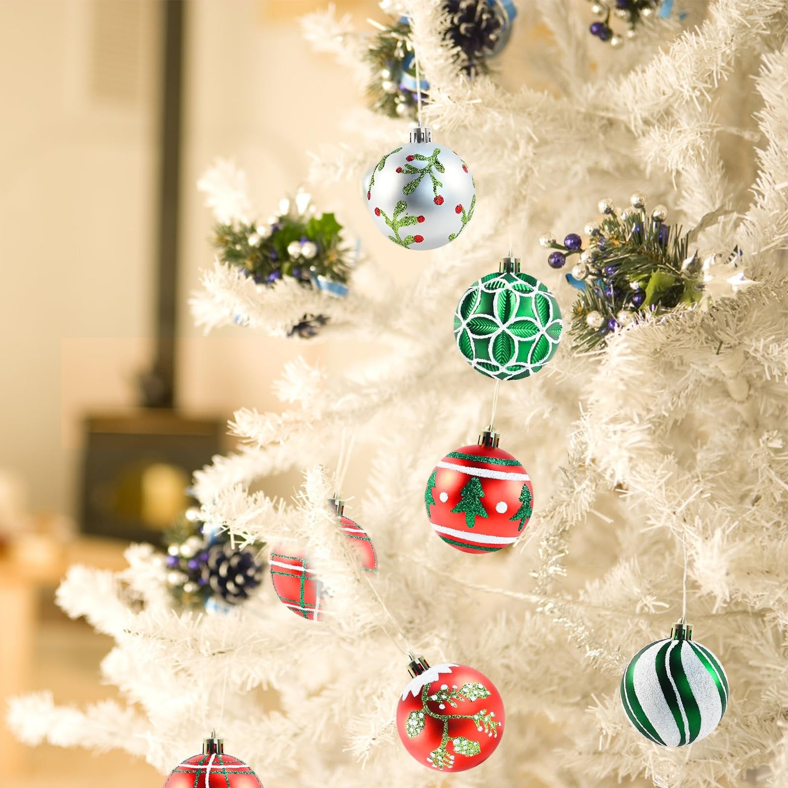 Assorted shatterproof Christmas ball ornaments in red, green, and silver hanging on a white artificial tree.