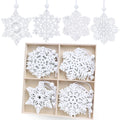 Set of 16 white wooden snowflake ornaments in 8 styles, shown hanging and in a wooden box.