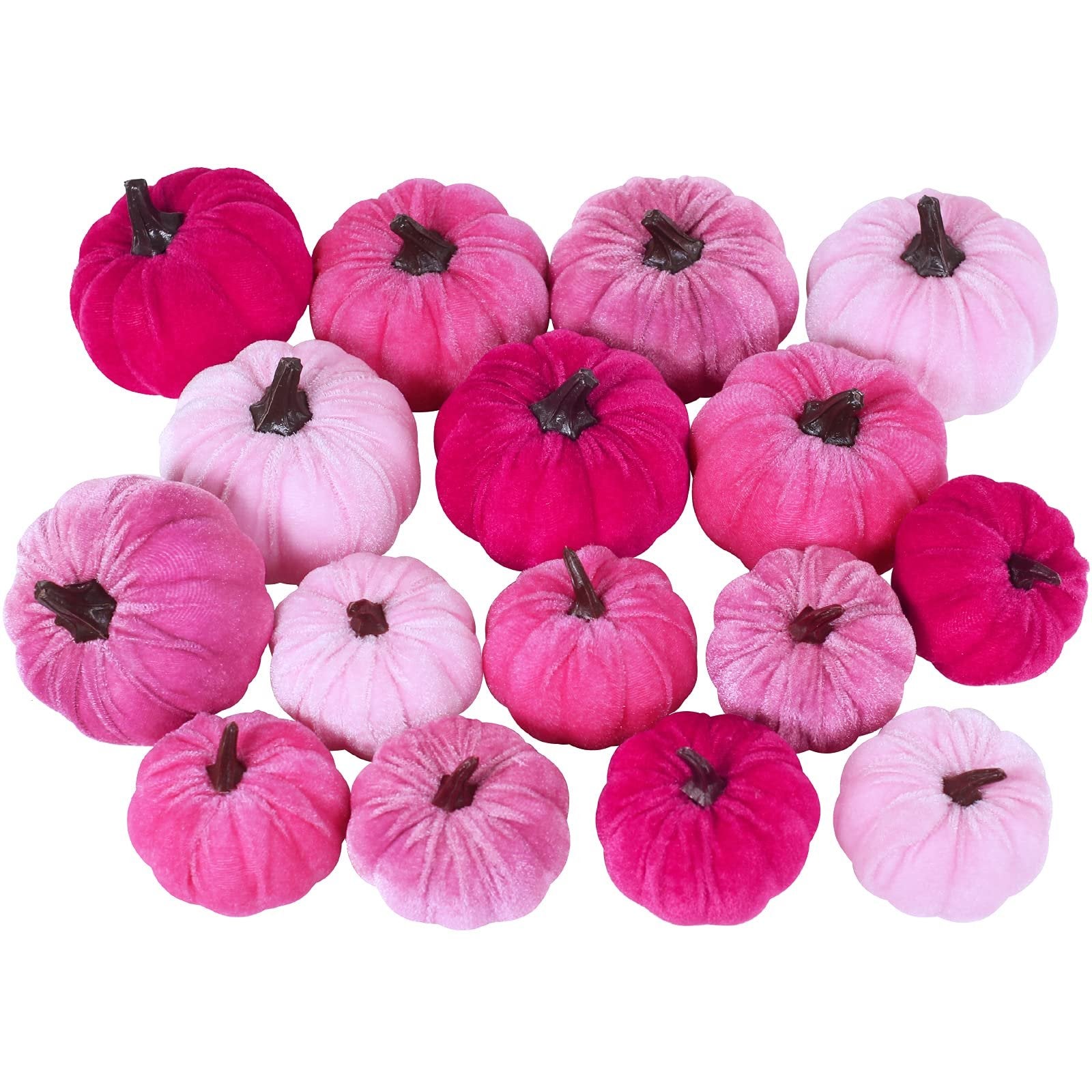 Assorted velvet pumpkins in various shades of pink arranged on a white background.