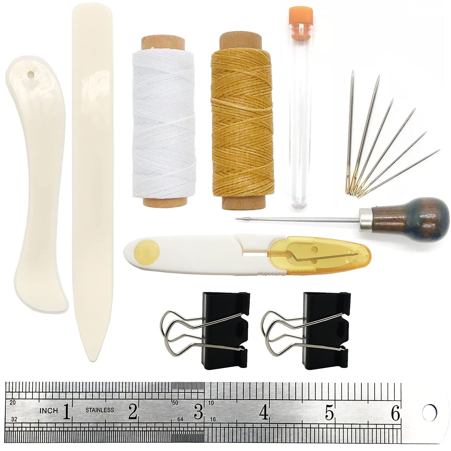 Bookbinding tools set including bone folder, creaser, needles, awl, thread, and clips on a ruler.