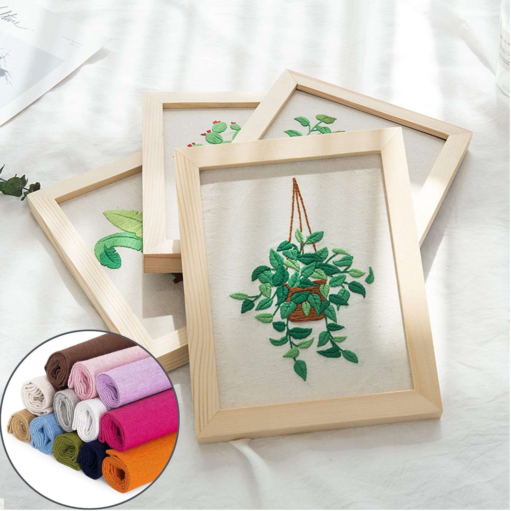 Embroidery frames with plant designs and a circular inset showing rolled fabric swatches in various colors.