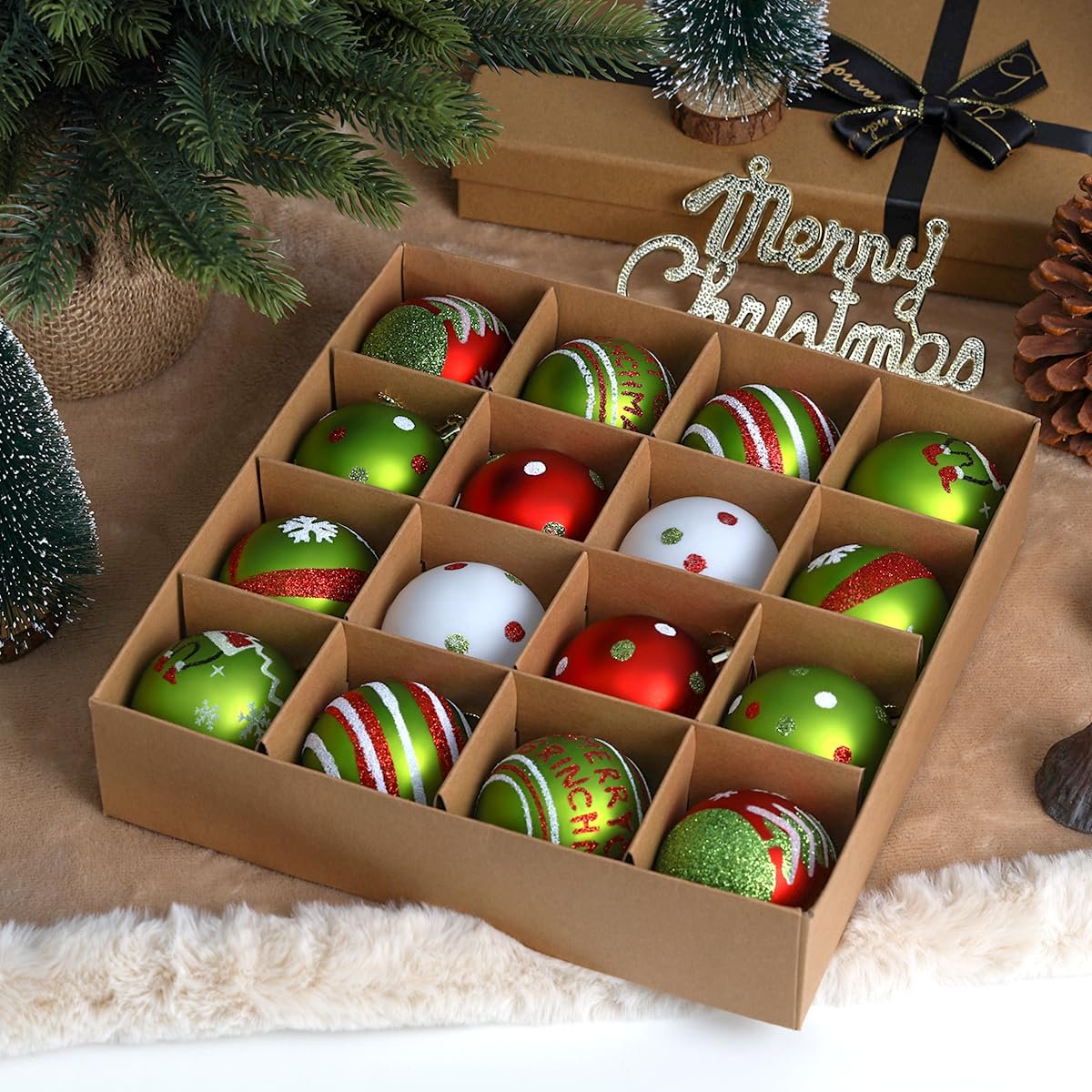 Box of 16 red, green, and white glittery Christmas tree ornaments with various festive designs.