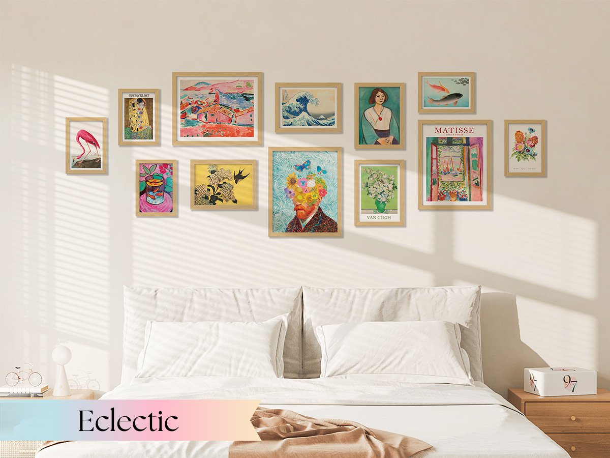 Gallery wall of unframed vintage botanical prints above a bed, featuring various art styles and subjects.