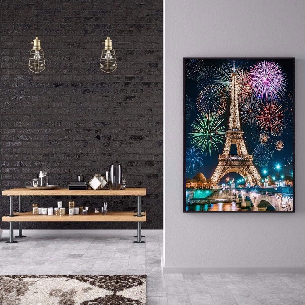 Eiffel Tower with fireworks at night, displayed as a framed diamond painting on a wall.