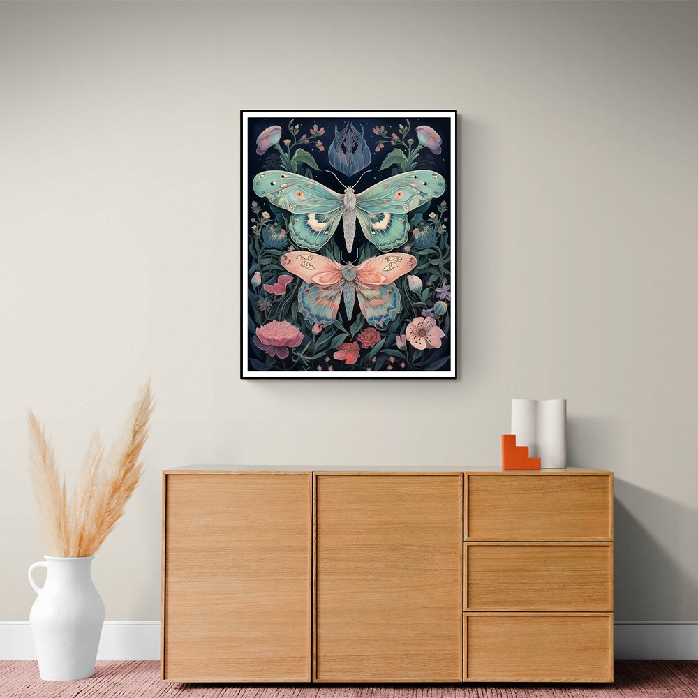 Framed butterfly and floral art print hanging above a wooden cabinet.