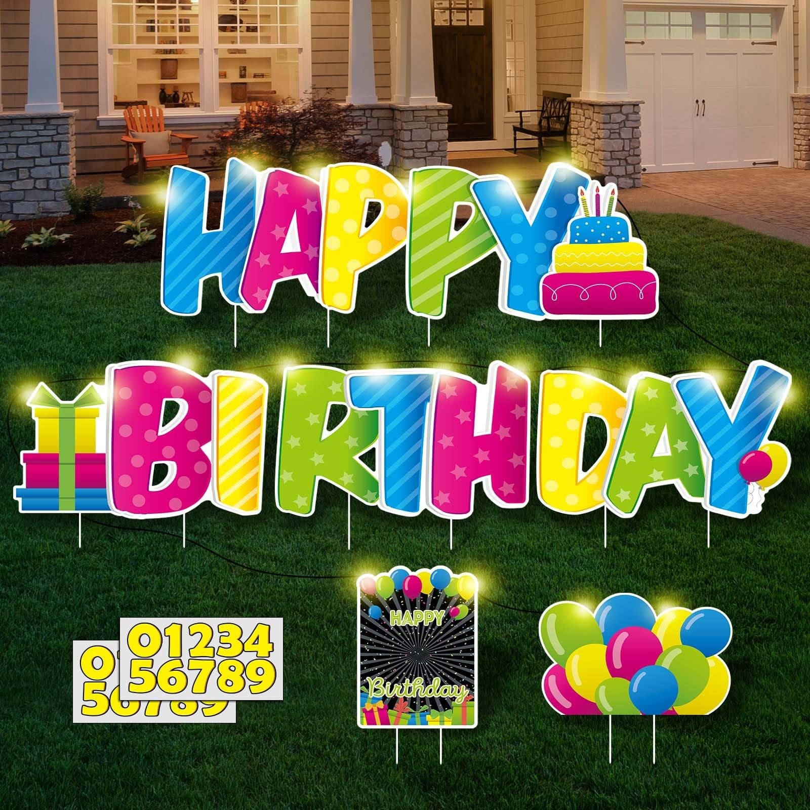 Colorful LED "Happy Birthday" yard signs with stakes and number stickers on a lawn in front of a house.