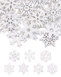 Pile of white wooden snowflake cutouts with a few individual snowflakes arranged below on a white background.