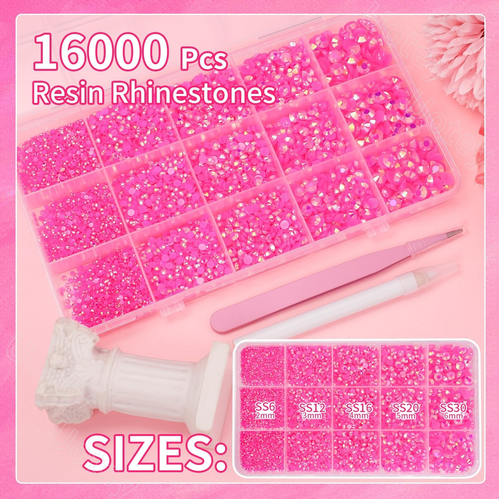 Hot pink resin rhinestones in a divided container with size labels and pickup tools.