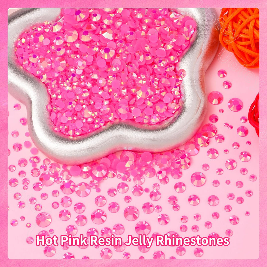Hot pink resin rhinestones in various sizes spilling out of a silver star-shaped container onto a pink background.