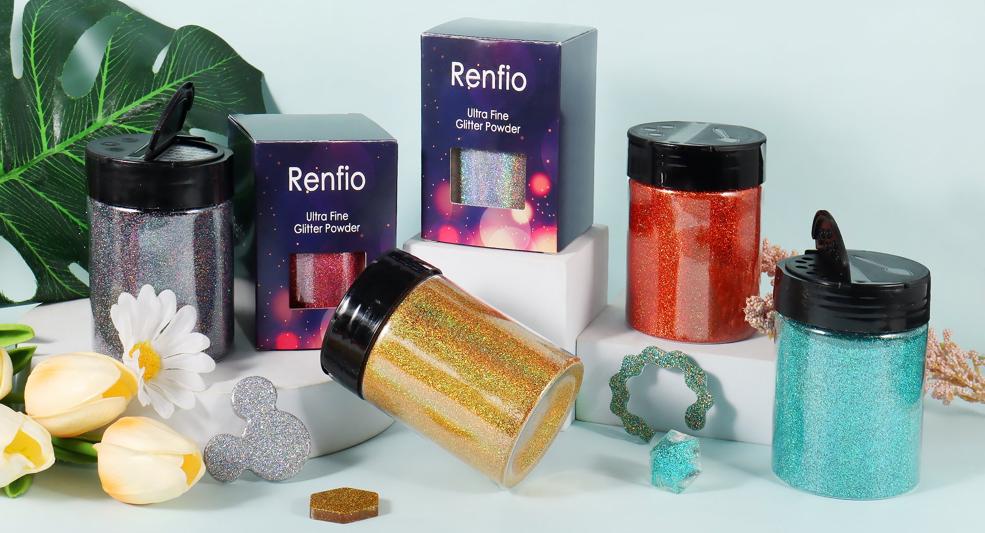 Assortment of glitter powder containers and decorative shapes on a light blue background with floral accents.