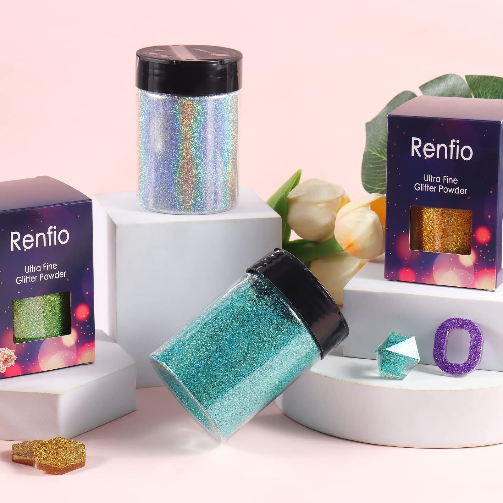 Three jars of holographic glitter powder in silver, green, and teal, with two boxes labeled Ultra Fine Glitter Powder.