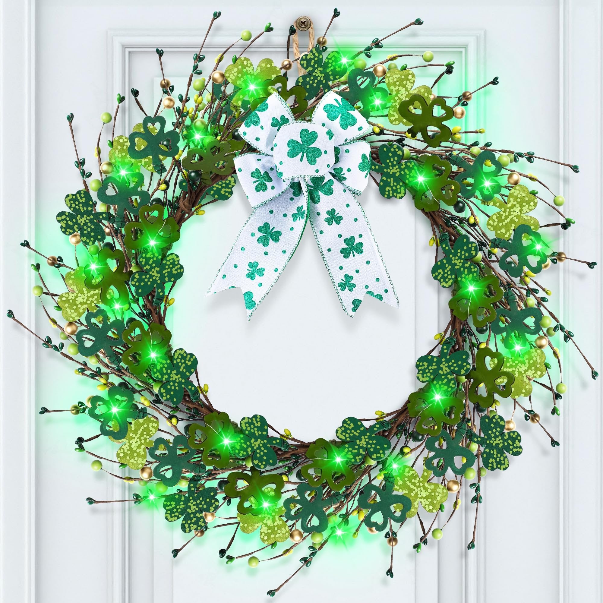 Lighted shamrock wreath with green LED lights and a white bow with shamrocks, hanging on a white door.