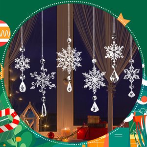 Crystal snowflake and icicle ornaments hanging in a window with fairy lights and gifts below.