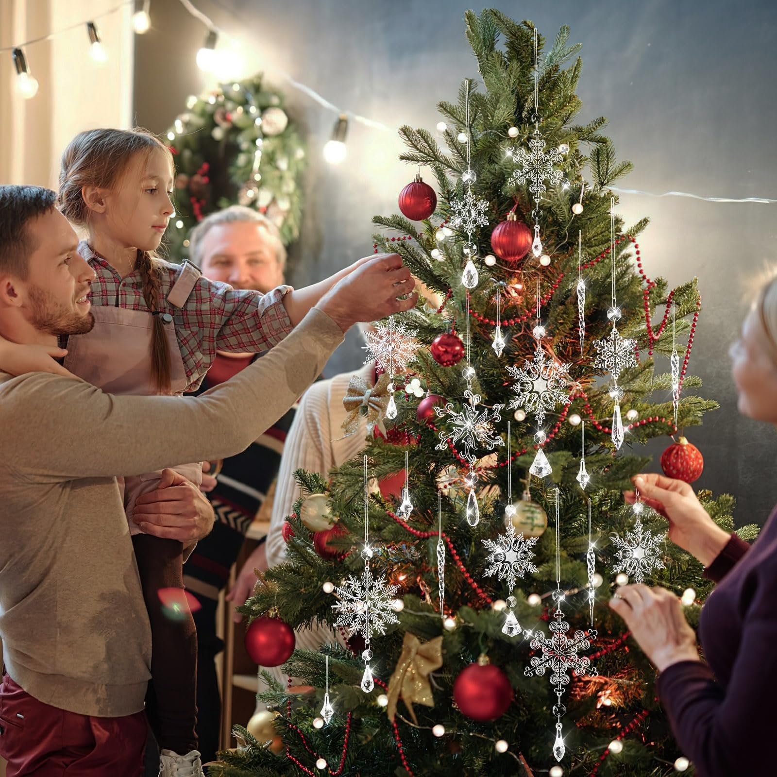Family decorating a Christmas tree with crystal snowflake and icicle ornaments
